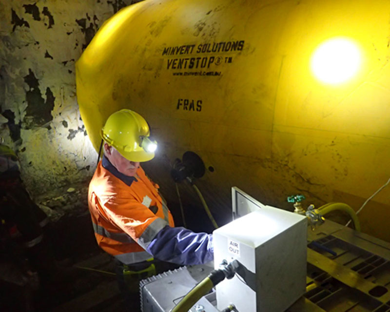 reusable inflatable VentStop VCD installed in an underground coal mine in NSW with an M2P staff member adjusting the activation box controls locally